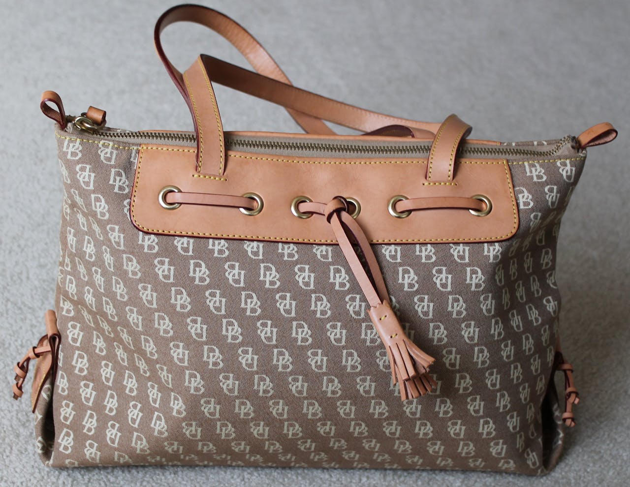 Mastering the First Impression: Your intriguing post title goes here Stylish Dooney & Bourke tote bag featuring beige canvas and leather trim, perfect for fashion enthusiasts.