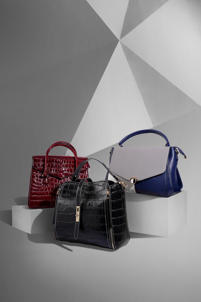 Crafting Captivating Headlines: Your awesome post title goes here Stylish leather handbags displayed on a geometric studio background.